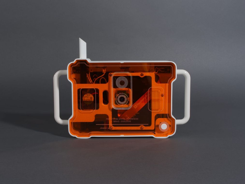 The back of ELEN seen through the orange plexiglass: the Raspberry Pi, camera module, wiring, and battery, with the team's engraving.