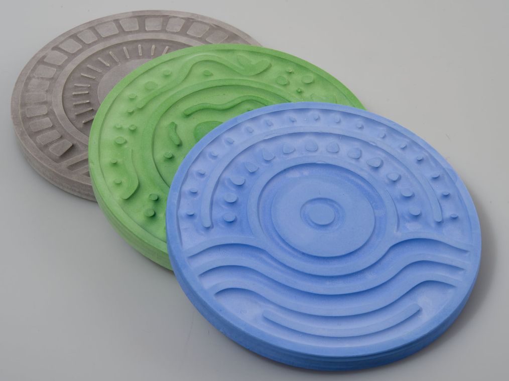 The three plaster disks for the park, the marina, and the train station, each a different pigment and texture.
