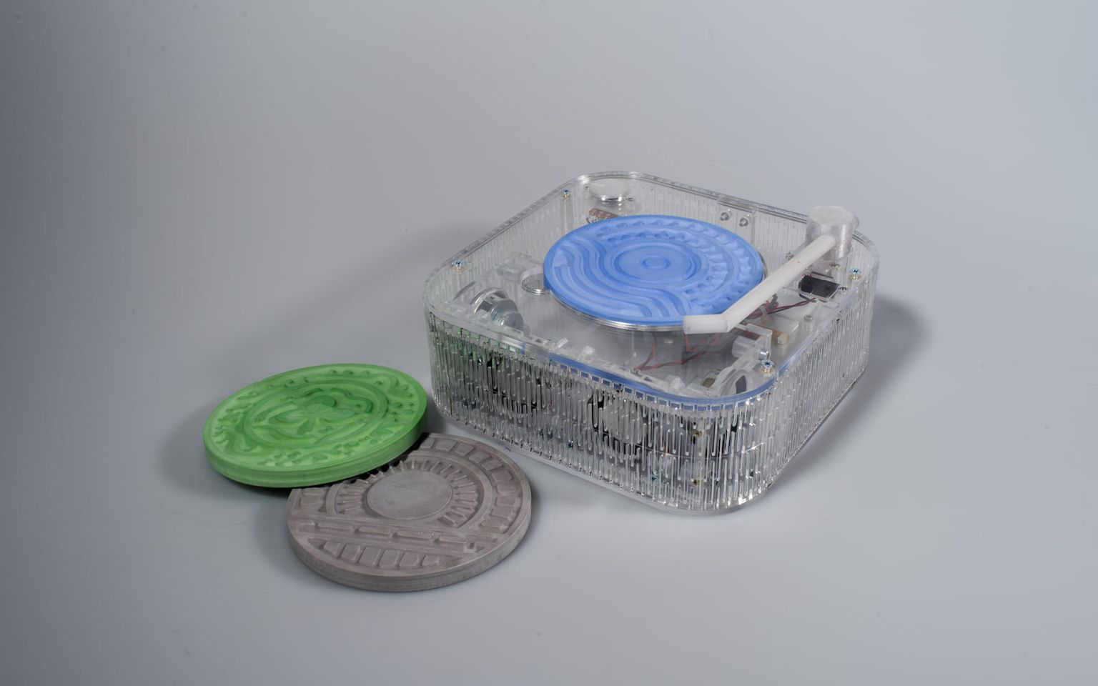 Human Loci: a transparent acrylic listening box with three plaster disks for a park, a marina, and a train station.