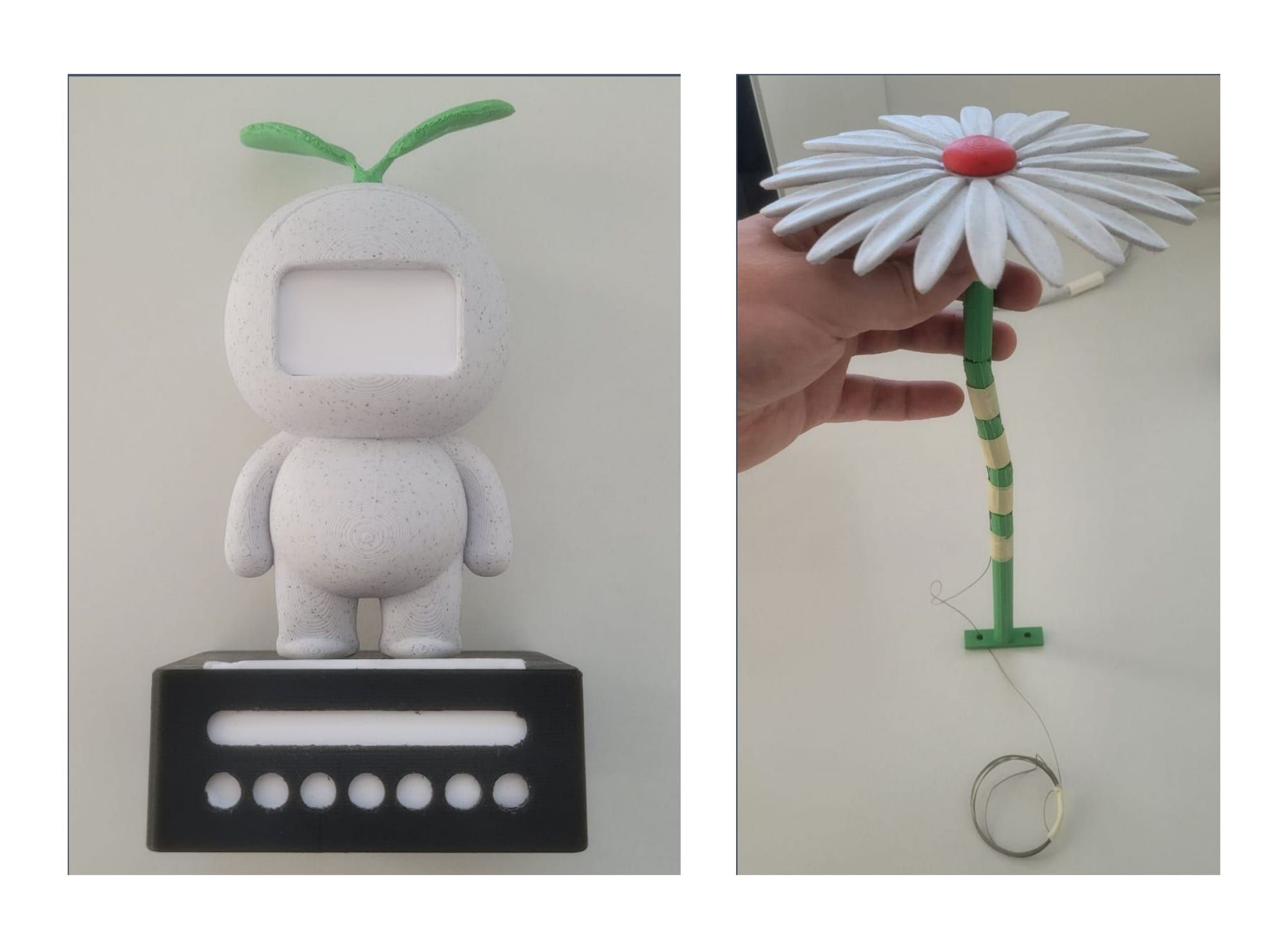 Two low-fidelity 3D-printed prototypes side by side: a white character with a screen-face slot, and a white daisy whose segmented stem has a cable run through it to actuate the flower.