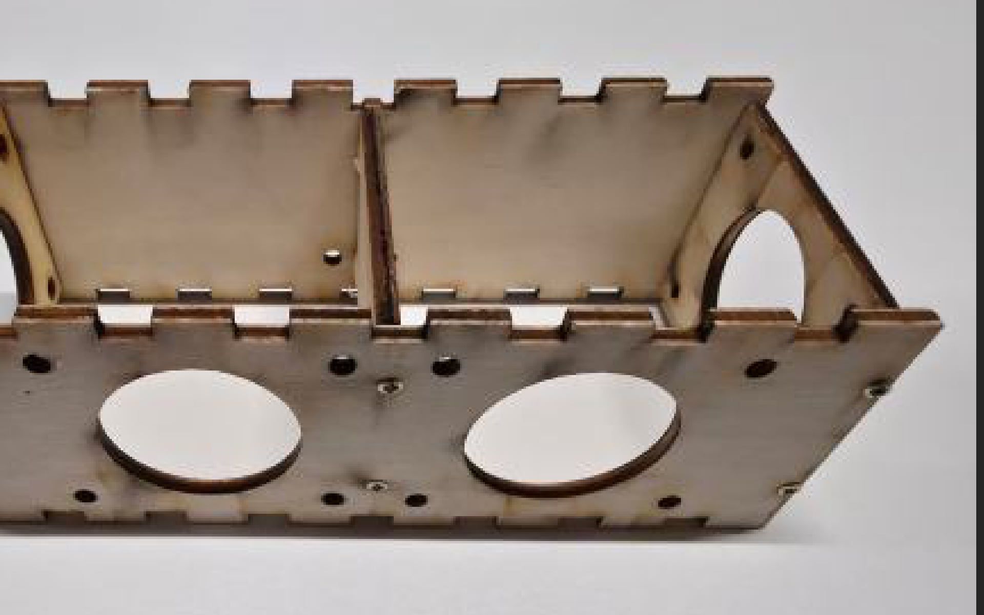 A wood two-chamber speaker prototype assembled with finger joints, used to validate the layout before cutting acrylic.